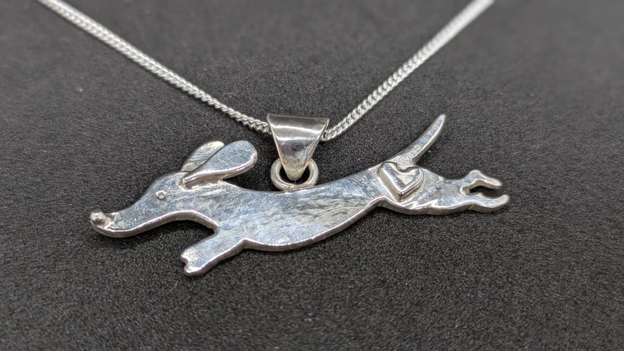Sterling silver dachshund pendant with heart detail and paw print bail