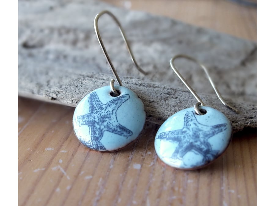 Starfish enamel earrings, blue background