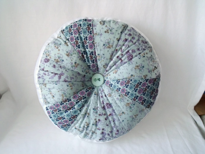 large plump pinwheel round scatter cushion mint and navy 13