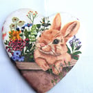 Decoupaged rabbit ceramic heart wall decoration.
