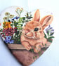 Decoupaged rabbit ceramic heart wall decoration.