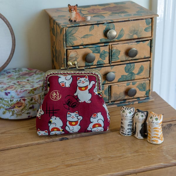 Coin purse featuring Chinese lucky cats in red and gold, with metallic lining