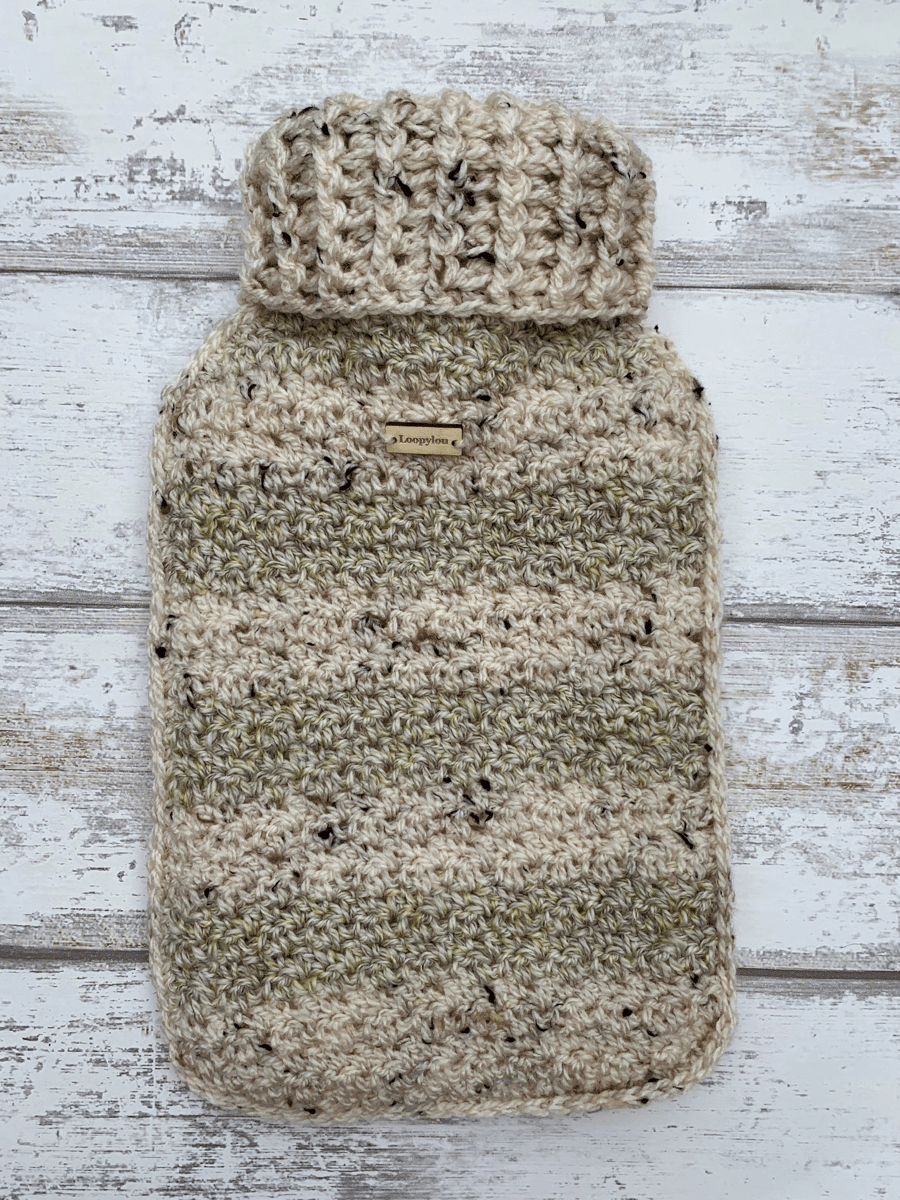 A hot water bottle and handmade crochet cover