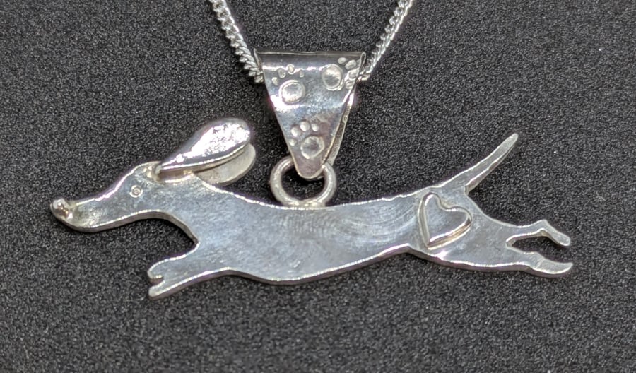 Sterling silver dachshund pendant with heart detail and paw print bail