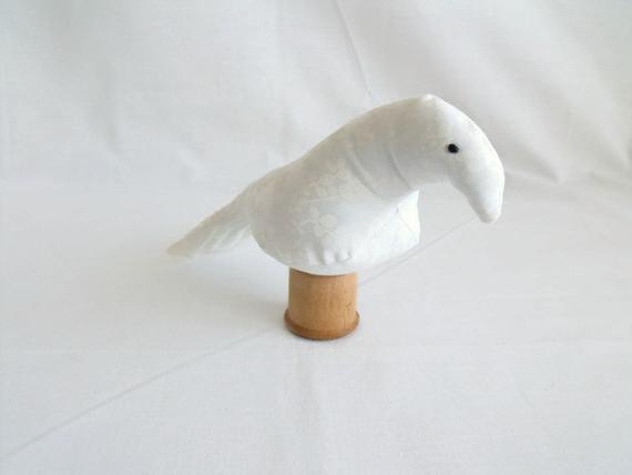novelty bird ornament or bird pin cushion on a vintage wooden bobbin, white