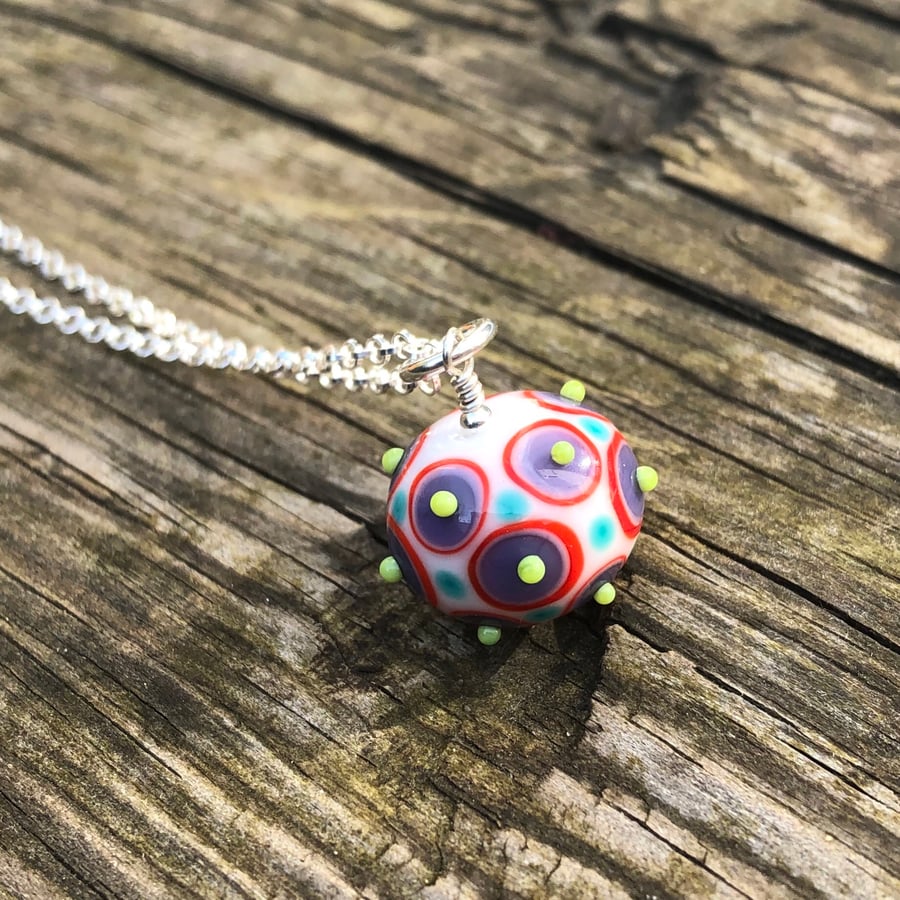 Multi coloured lampwork pendant with raised bumps. Sterling Silver 