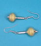 Paper beaded pale green earrings on an ornate metal rod