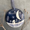 Ceramic Winter scene hanging decoration.