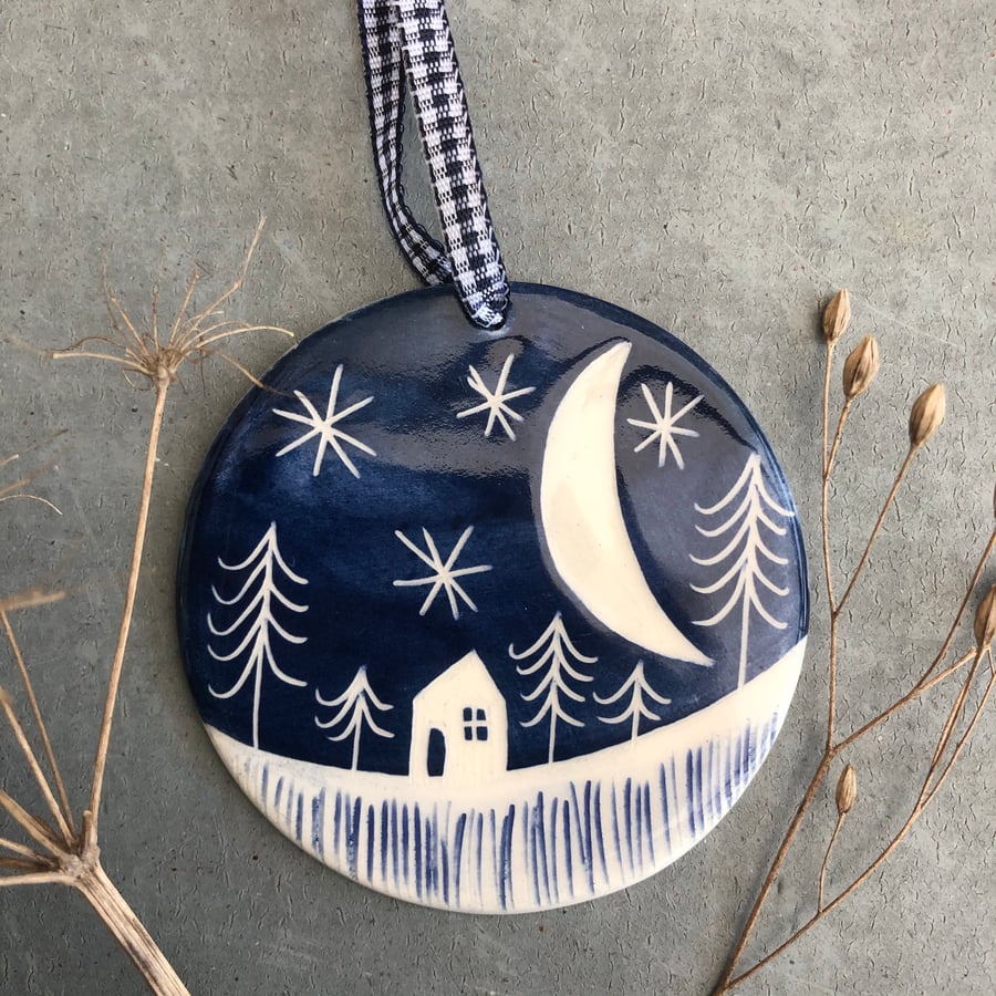 Ceramic Winter scene hanging decoration.