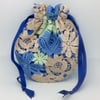 Small, drawstring Potli, wristlet bag, lace flowers on blue.