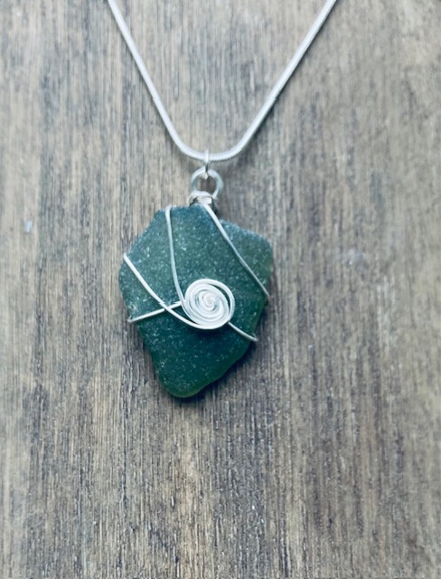 Green sea glass pendant with spiral 