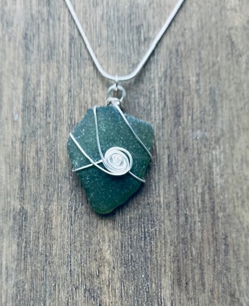 Green sea glass pendant with spiral 