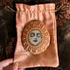  Painted pebble, serene meditation face, with vintage crochet doily