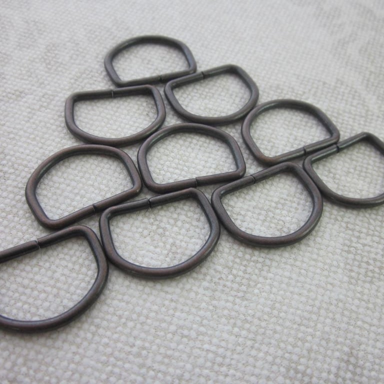 10 Small Bronze Tone D Rings