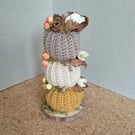 Crochet stacking pumpkins on a log base. Autumn decoration 