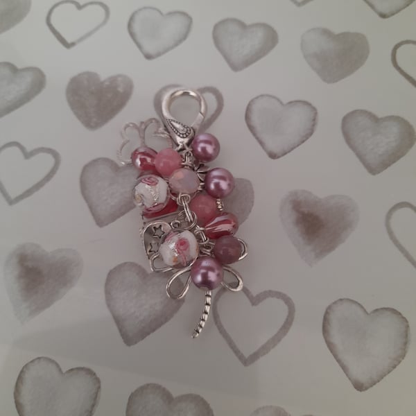 SHADES OF PINK AND SILVER FLORAL DRAGON FLY BAG CHARM.