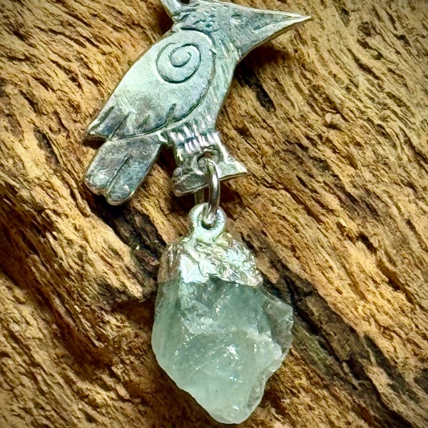 Silver raven and aquamarine gemstone pendant 