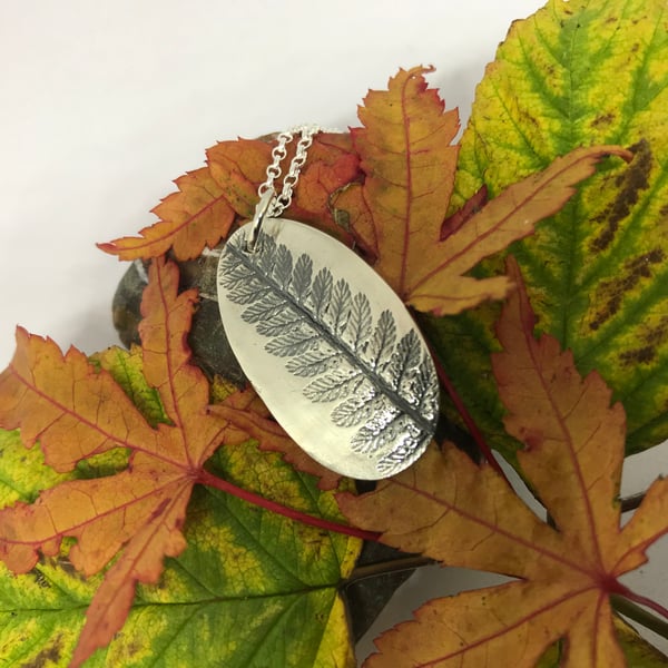 Silver fern imprint pendant