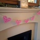 Linoprinted bunting featuring handprinted hearts.