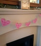Linoprinted bunting featuring handprinted hearts.