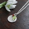 Textured recycled Eco Silver disc pendant with festive peridot and garnet