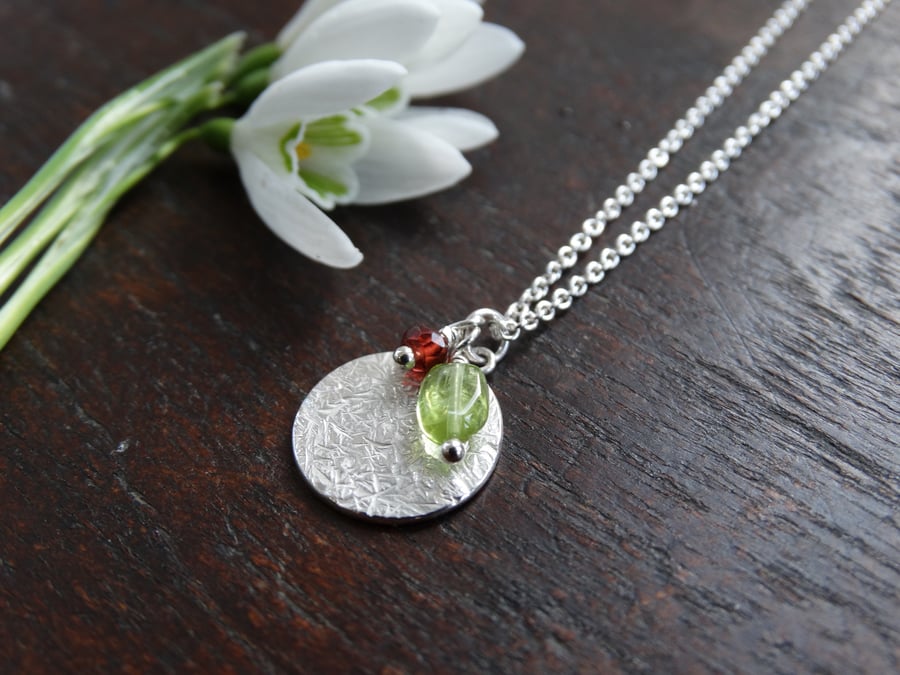 Textured recycled Eco Silver disc pendant with festive peridot and garnet