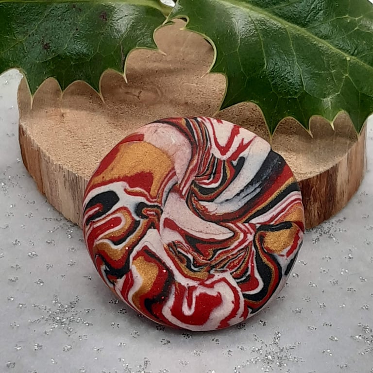 Red, gold, black and white festive brooch