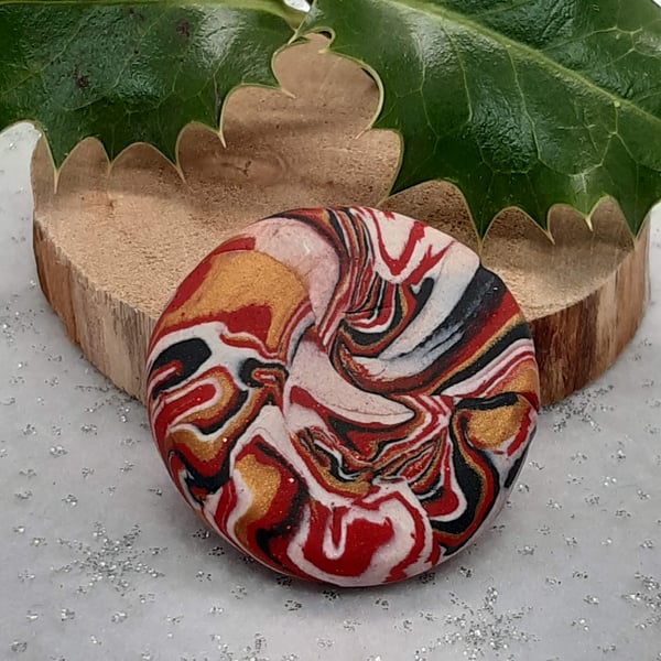 Red, gold, black and white festive brooch