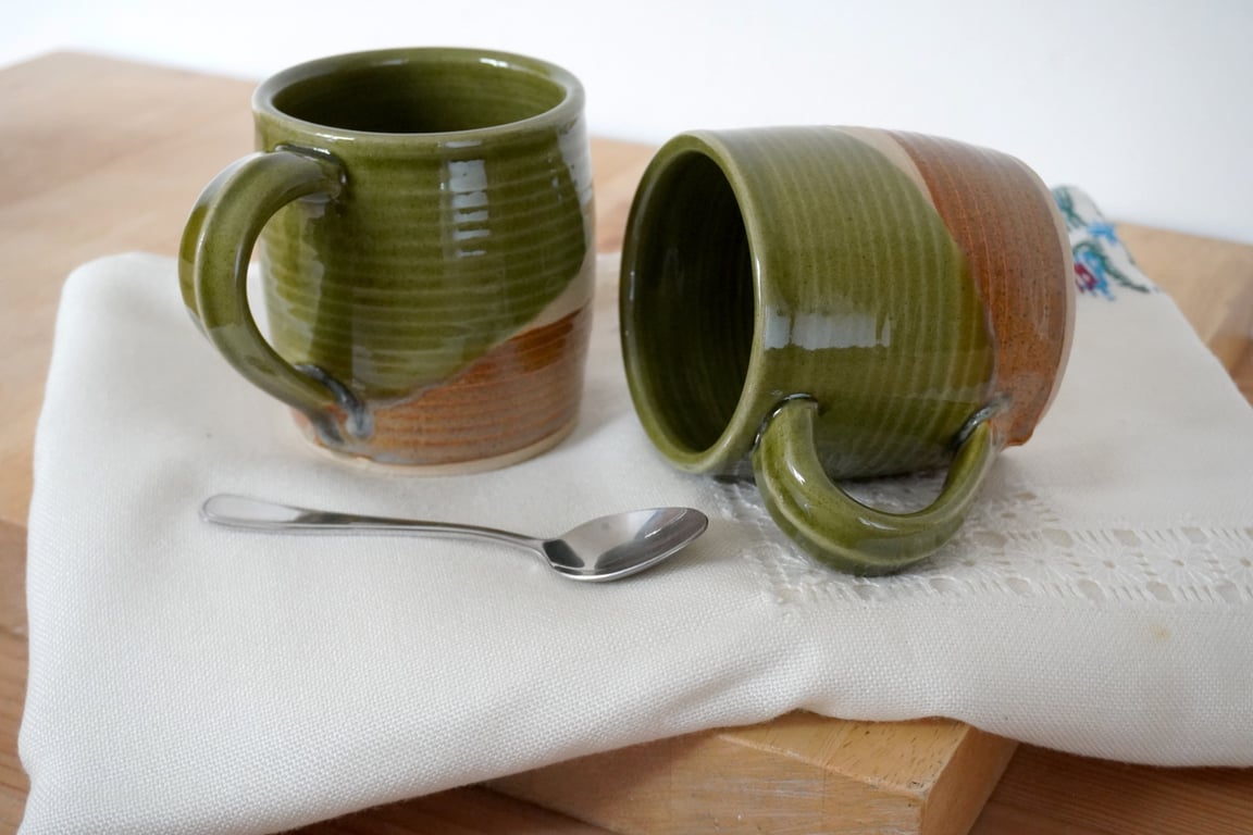 One cozy stoneware pottery tea mug glazed in forest green and brown