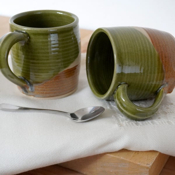 One cozy stoneware pottery tea mug glazed in forest green and brown