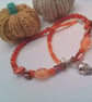 Silver Skull Pendant on an Orange Red Purple & Pink Shell Beaded Necklace - Image 6