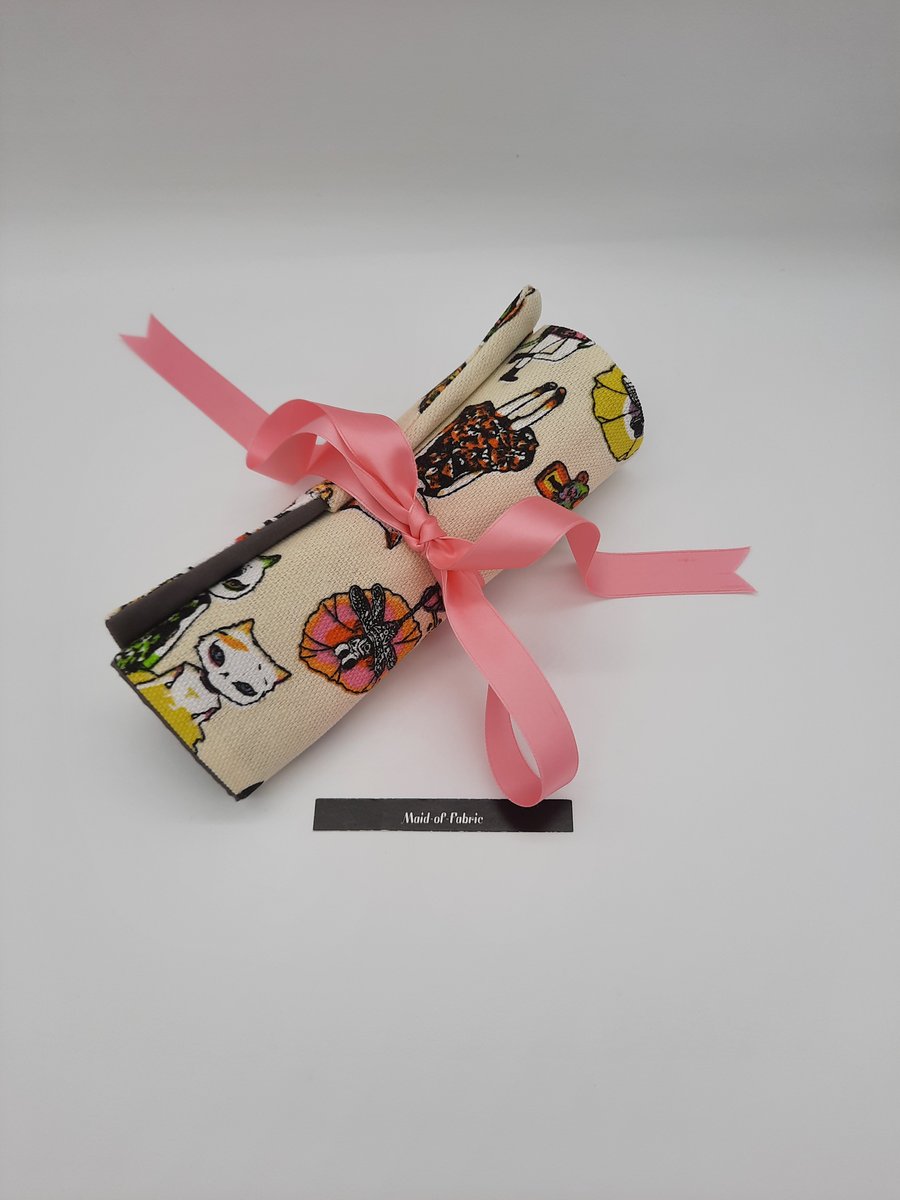 Crazy cats make up wrap with pink ribbon. 