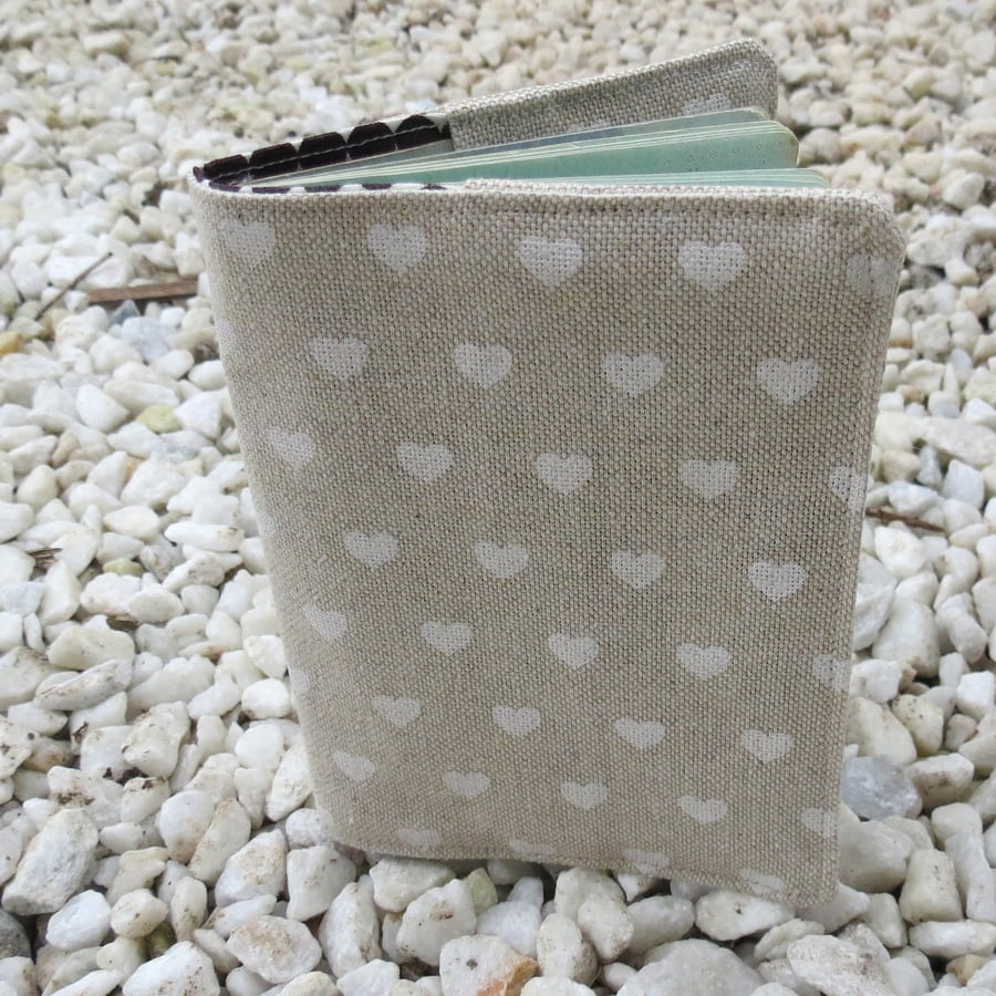 A passport sleeve with a scandi hearts design.  Passport cover. 