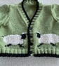 Green baby cardigan with sheep designs on the front - Image 2