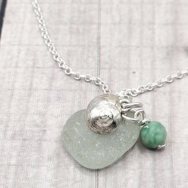 Real shells coated in silver with sea glass and bead, unique item!
