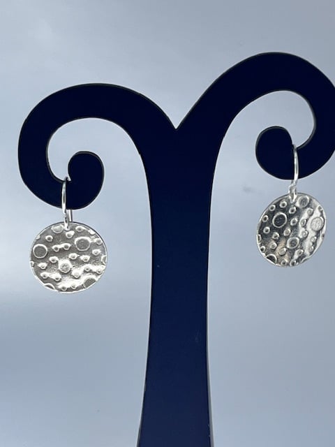 Silver round earrings with bubbles texture