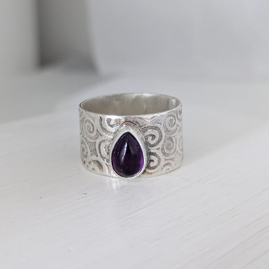 Wide band celtic ring with amethyst