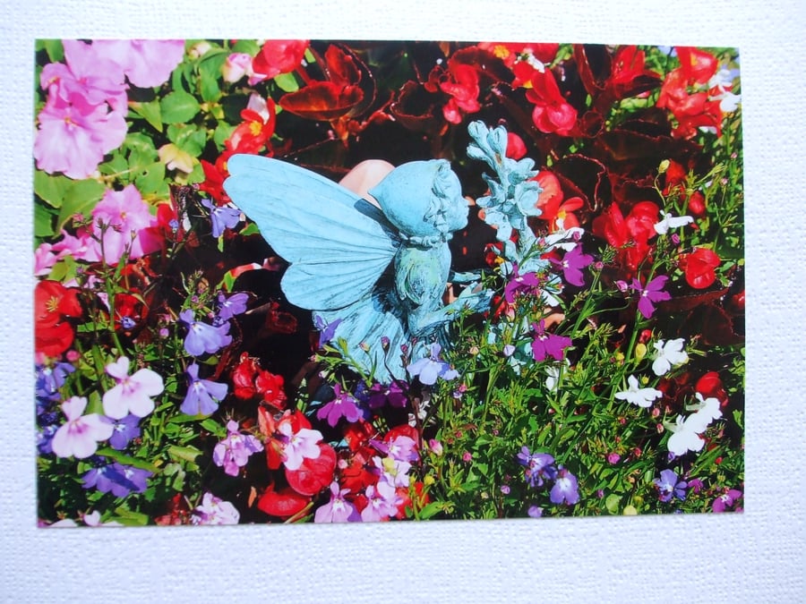 Photographic greetings card of our Fairy smelling the flowers.