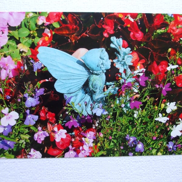 Photographic greetings card of our Fairy smelling the flowers.