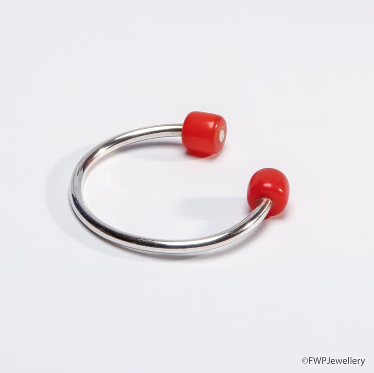 Open silver bangle with orange beads