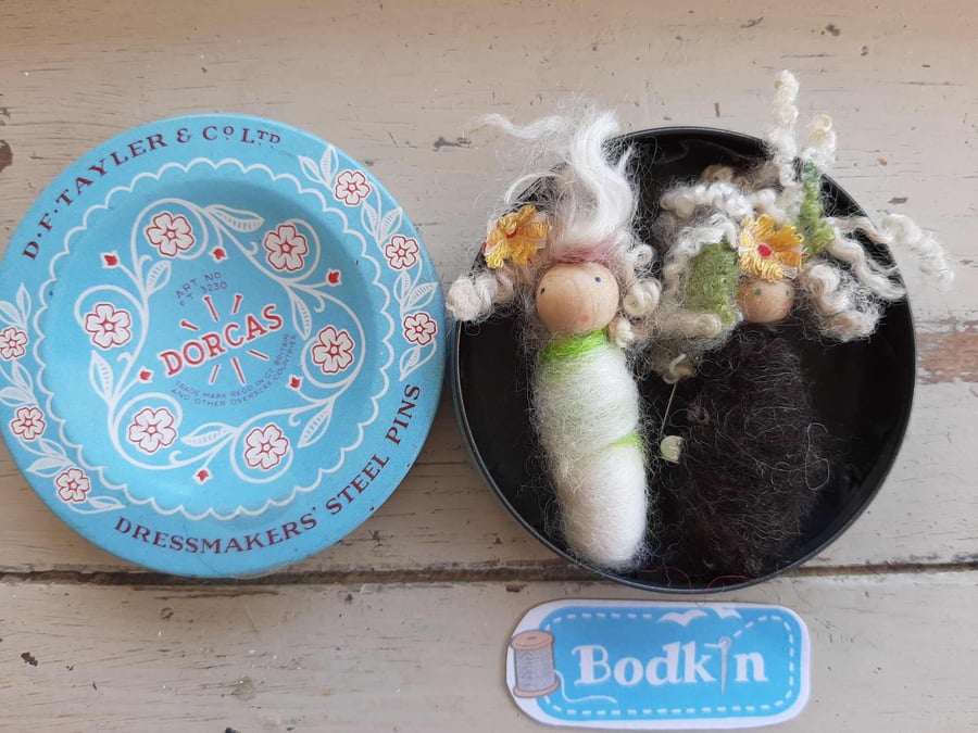 Two  baby bodkin brooches in vintage tin.