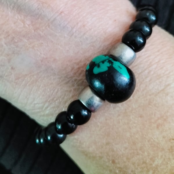 Black acrylic beads with a Black and Turquoise centre