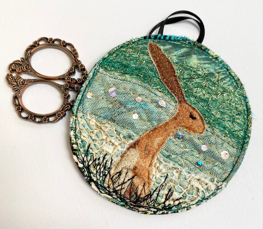 Upcycled embroidered harvest hare home decoration. 