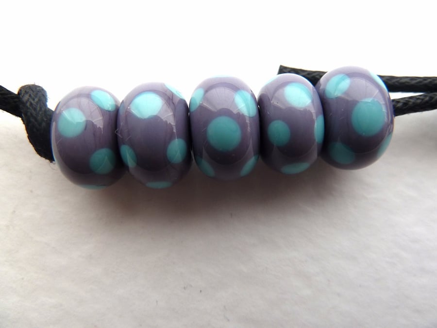 handmade lampwork glass beads. purple with blue spots