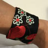 Small wrist cuff, black with red and cream flowers