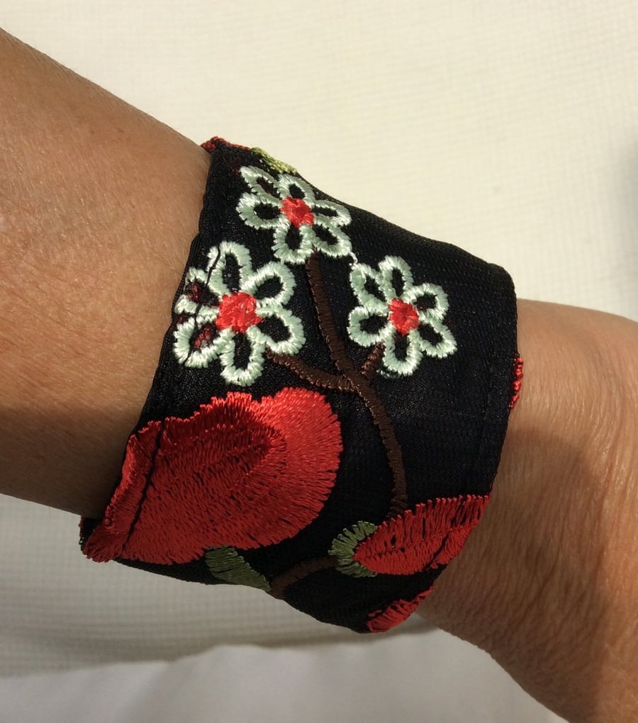 Small wrist cuff, black with red and cream flowers