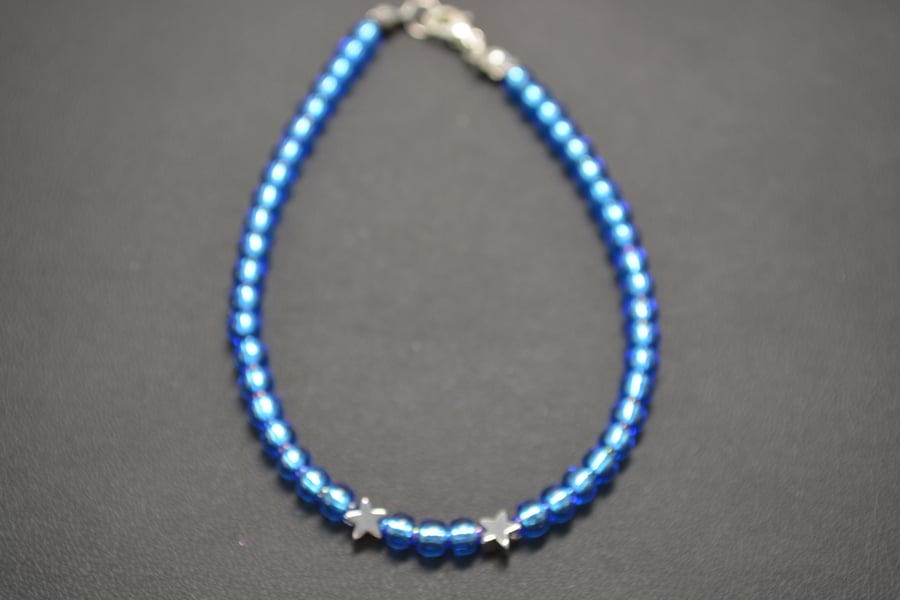 Light blue seed beaded bracelet with silver stars