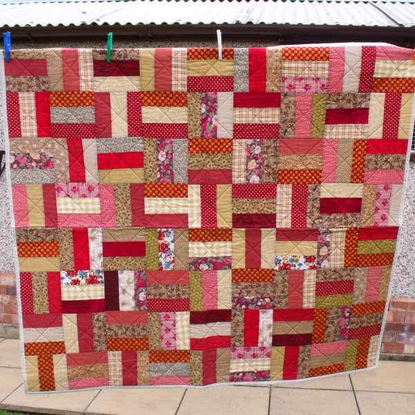 rail fence patchwork quilt in autumnal colours, quilted sofa throw