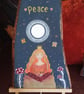Painted wood piece "Peace" with display stand 