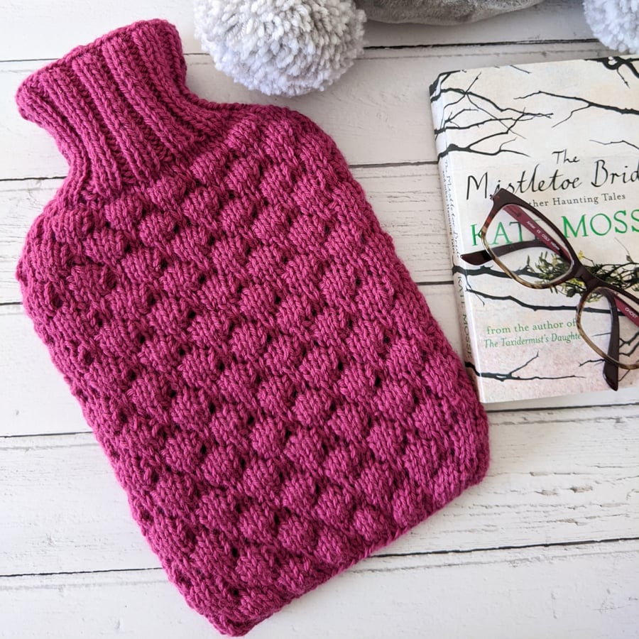 Raspberry pink knitted hot water bottle cover